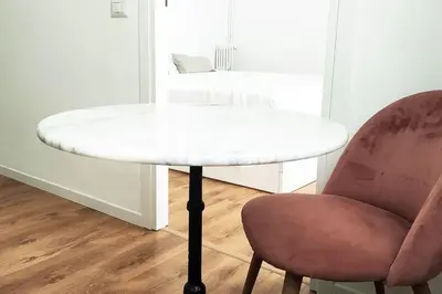 a white table and a chair next to a desk at Appartamento a due passi da San Pietro, Vaticano in Rome