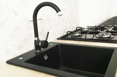 a kitchen counter with a sink and a stove at Appartamento a due passi da San Pietro, Vaticano in Rome