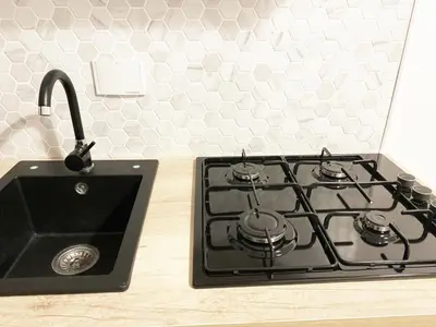 a kitchen counter with a stove and a sink at Appartamento a due passi da San Pietro, Vaticano in Rome