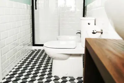 a bathroom with a toilet and a black and white tile floor at Appartamento a due passi da San Pietro, Vaticano in Rome