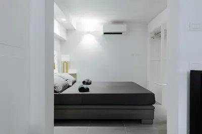 a white bedroom with a bed and a walk in shower at Pantheon Experience Suite in Rome