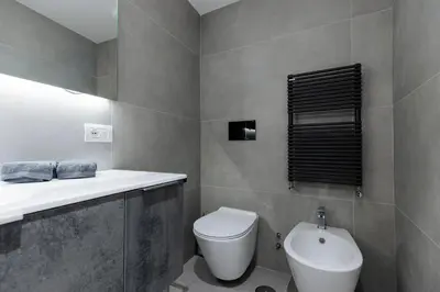 a bathroom with a white toilet and a sink at Pantheon Experience Suite in Rome