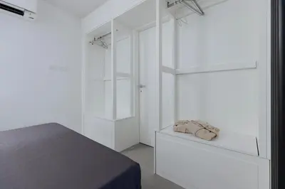 a white bedroom with a bed and white shelves at Pantheon Experience Suite in Rome