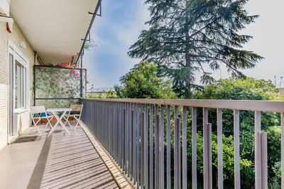 a balcony with a table and chairs on it at Luxury apartment front of Cavalieri Hilton Hotel in Rome