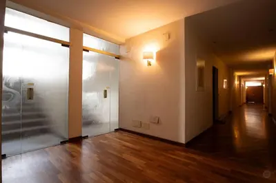 an empty hallway with a glass door in a building at Luxury apartment front of Cavalieri Hilton Hotel in Rome