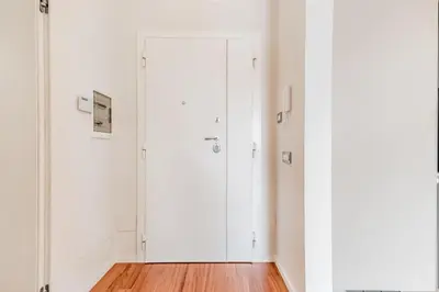 a room with white cabinets and wood floors at Luxury apartment front of Cavalieri Hilton Hotel in Rome