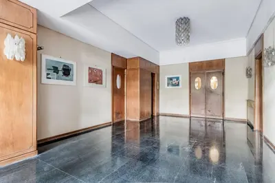 a large room with a hallway with wood paneling at Luxury apartment front of Cavalieri Hilton Hotel in Rome