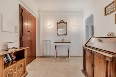 a room with a table and a mirror on the wall at Garbatella Elegant Apartment in Rome