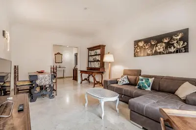 a living room with a couch and a table at Garbatella Elegant Apartment in Rome