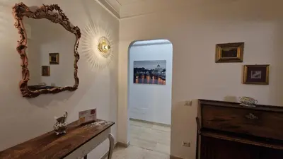 a hallway with a mirror and a dresser at Garbatella Elegant Apartment in Rome