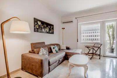 a living room with a couch and a table at Garbatella Elegant Apartment in Rome