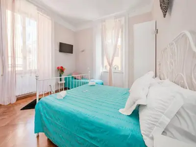 a white bedroom with an elephant pillow on a bed at Sesto Suites Central in Rome