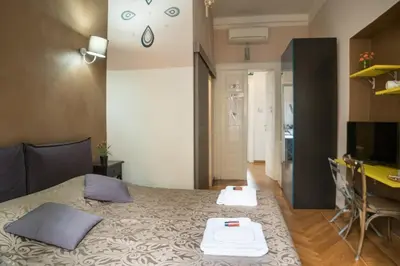 a bedroom with a bed with two pillows and a desk at Sesto Suites Central in Rome