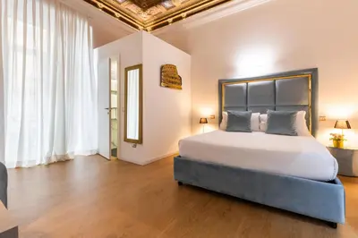 a bedroom with a large bed in a room at Cavour LR Collection in Rome