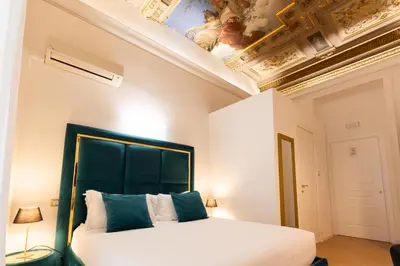 a bedroom with a large bed with a ceiling at Cavour LR Collection in Rome