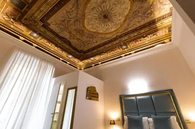 a bedroom with a gold ceiling and a bed at Cavour LR Collection in Rome