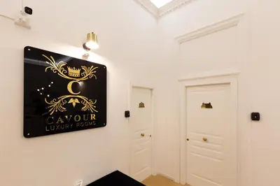 a room with a black and gold sign on the wall at Cavour LR Collection in Rome