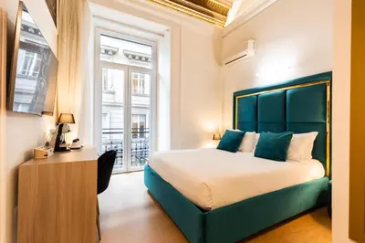 a bedroom with a large bed and a window at Cavour LR Collection in Rome