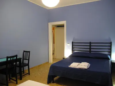 a bedroom with a bed and a table and chairs at Arches Inn in Rome