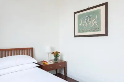 a bedroom with a bed and a table with a picture at Relais Quinto Piano in Rome