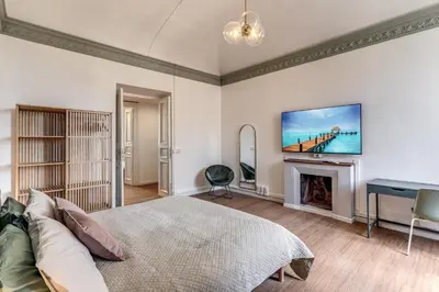 a bedroom with a bed and a fireplace and a tv at The Great Green in Rome