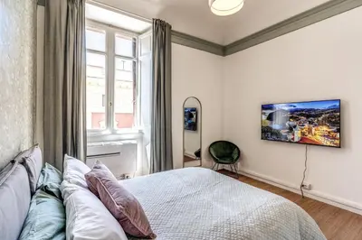 a bedroom with a bed and a large window at The Great Green in Rome
