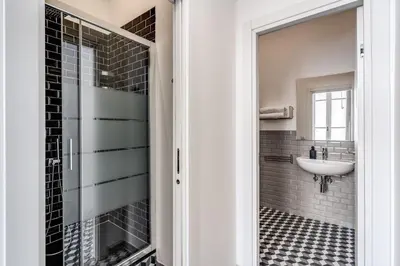 a bathroom with a sink and a glass door at The Great Green in Rome