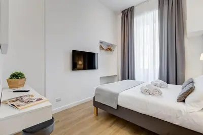 a hotel room with a bed and a window at Colonna Luxury Apartment in Rome