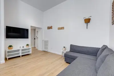 a living room with a couch and a flat screen tv at Colonna Luxury Apartment in Rome