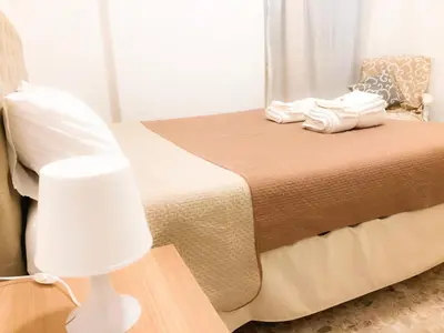 a bedroom with a bed with a white lamp at Garbatella House in Rome