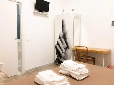 a room with a table with two white towels on it at Garbatella House in Rome