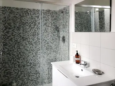 a bathroom with a sink and a glass shower at Garbatella House in Rome