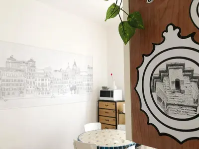 a room with a mirror on the wall next to a table at Garbatella House in Rome