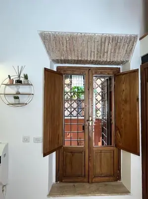 a wooden door in a room with a window at Monti Wood Loft in Rome