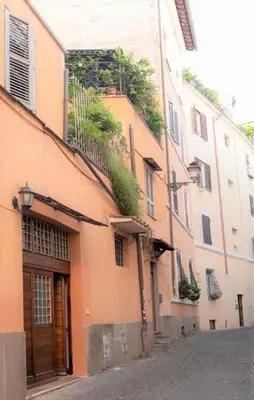 an orange building with a door and a street at Monti Wood Loft in Rome