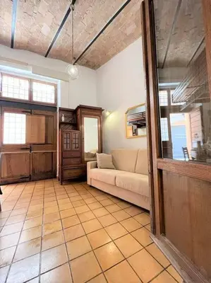 a living room with a couch and a table at Monti Wood Loft in Rome