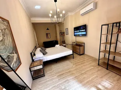 a bedroom with a white bed and a wooden floor at Luxurious flat close to the Vatican/metro in Rome