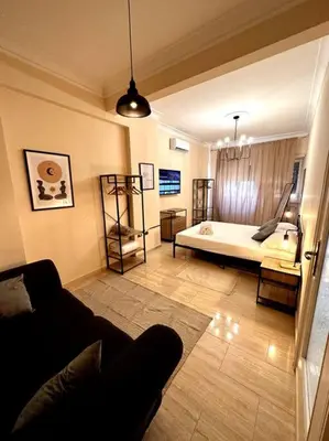 a living room with a couch and a bed at Luxurious flat close to the Vatican/metro in Rome