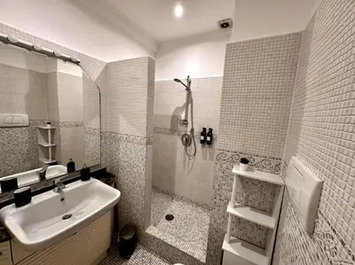a white bathroom with a sink and a shower at Luxurious flat close to the Vatican/metro in Rome