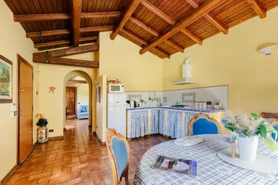 a kitchen and dining room with a table and chairs at Peaceful Haven in Rome in Rome