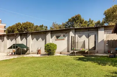 a large building with a grass yard in front of it at Peaceful Haven in Rome in Rome