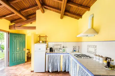 a kitchen with yellow walls and a white refrigerator at Peaceful Haven in Rome in Rome