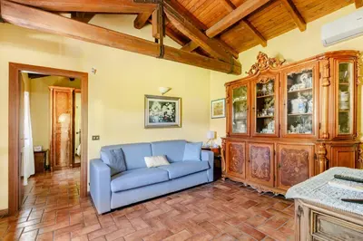 a living room with a blue couch and a wooden cabinet at Peaceful Haven in Rome in Rome