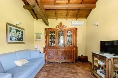 a living room with a blue couch and a wooden cabinet at Peaceful Haven in Rome in Rome