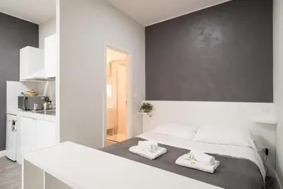 a white bedroom with two towels on a bed at Magenta Collection Terrione 25 in Rome