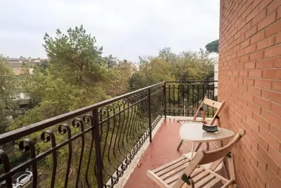 two chairs and a table on a balcony at Magenta Collection Terrione 25 in Rome