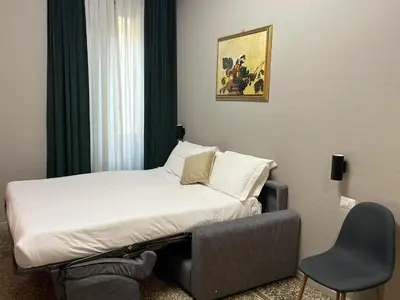 a bed and a chair in a hotel room at Vatican museum guest house in Rome