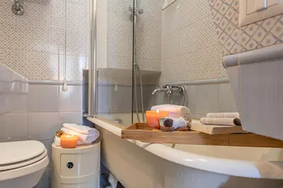 a bathroom with a toilet and a counter with towels at Demetra - Little Loft a Trastevere in Rome