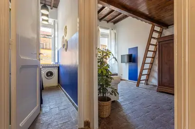 a hallway with a staircase and a washing machine at Demetra - Little Loft a Trastevere in Rome