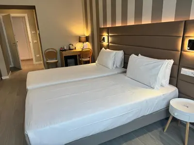 a large white bed in a hotel room at RESIDENZA 62 in Rome